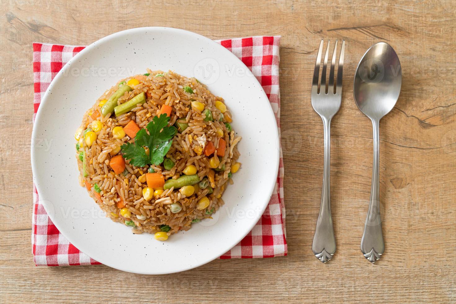 Fried rice with green peas, carrots, and corn - vegetarian and healthy food style photo