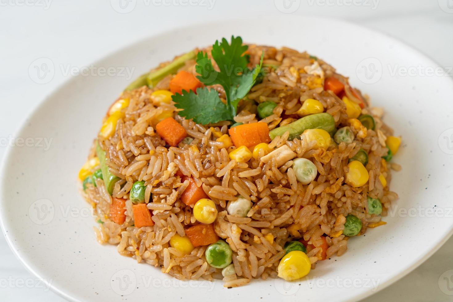 Fried rice with green peas, carrots, and corn - vegetarian and healthy food style photo