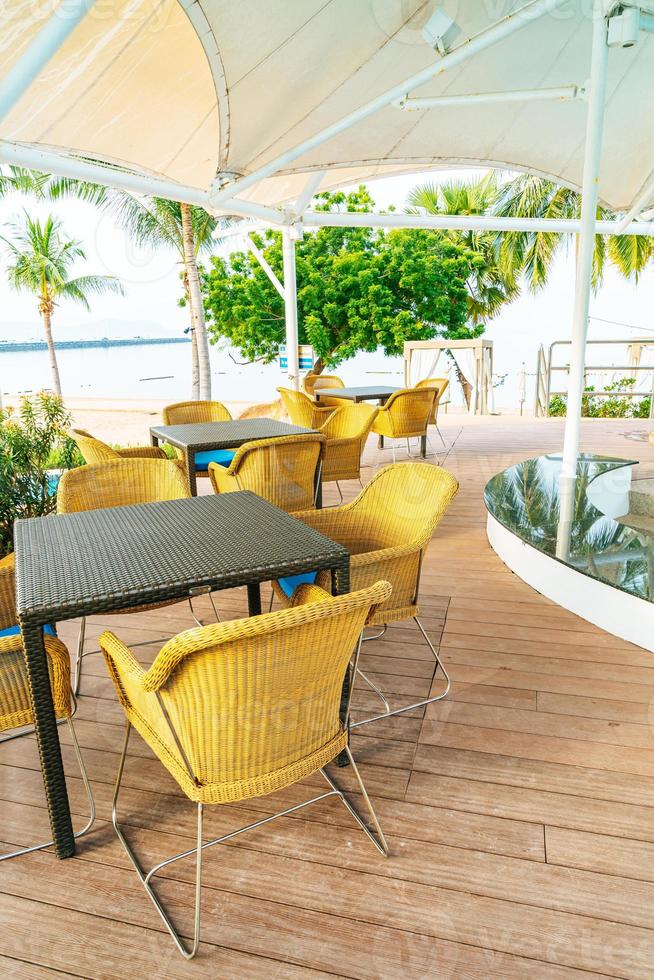 Empty outdoor patio chair near swimming pool photo