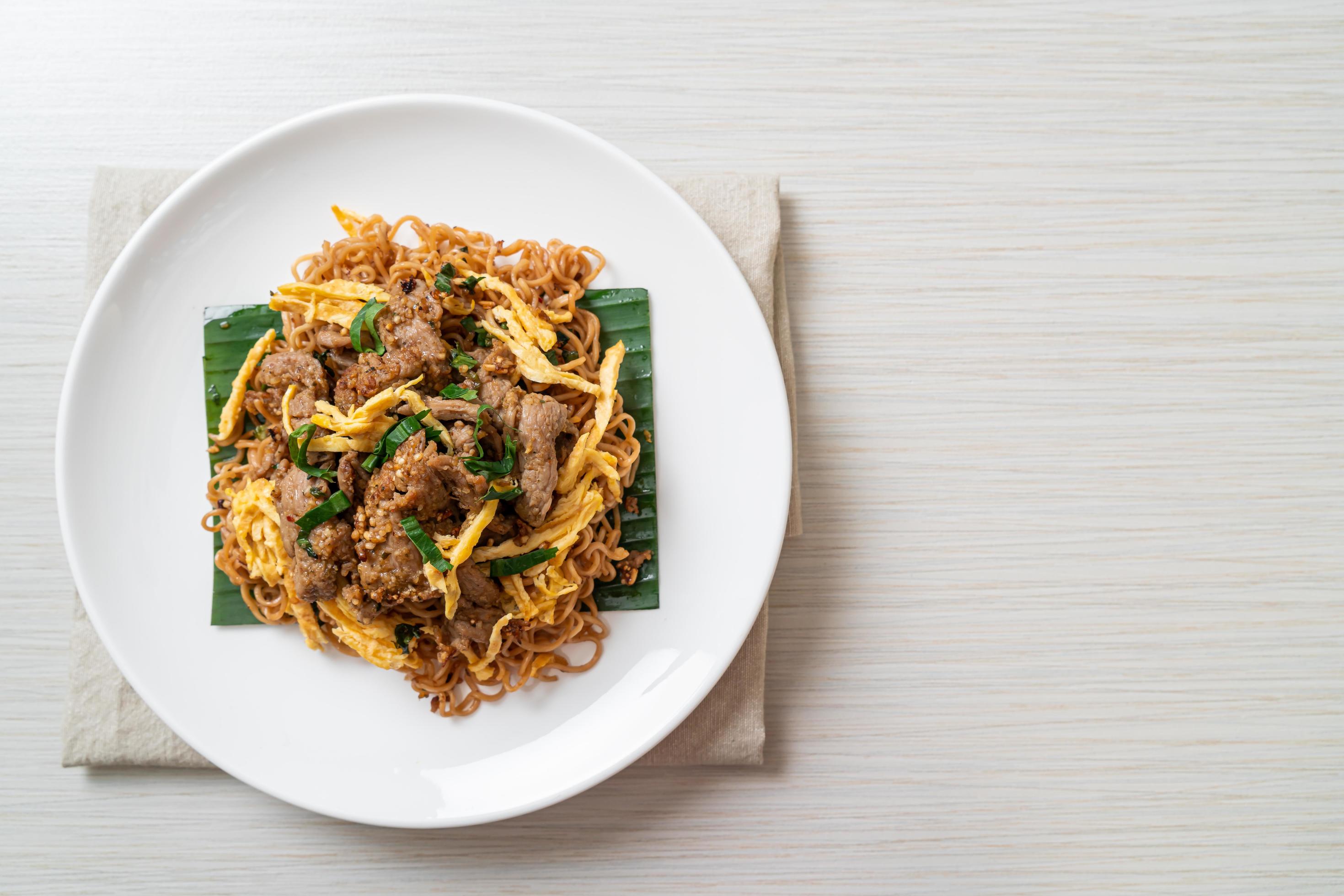Stir-fried instant noodle with pork and egg - Asian local street food
