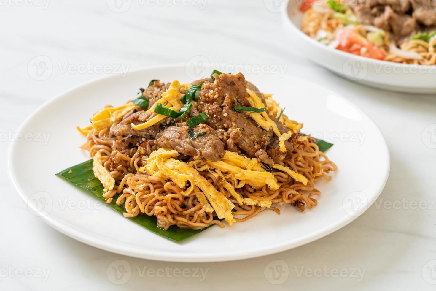 Stir-fried instant noodle with pork and egg - Asian local street food style photo