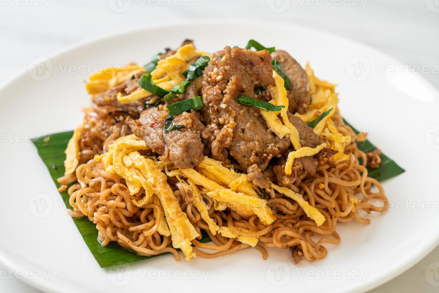 Stir-fried instant noodle with pork and egg - Asian local street food style photo