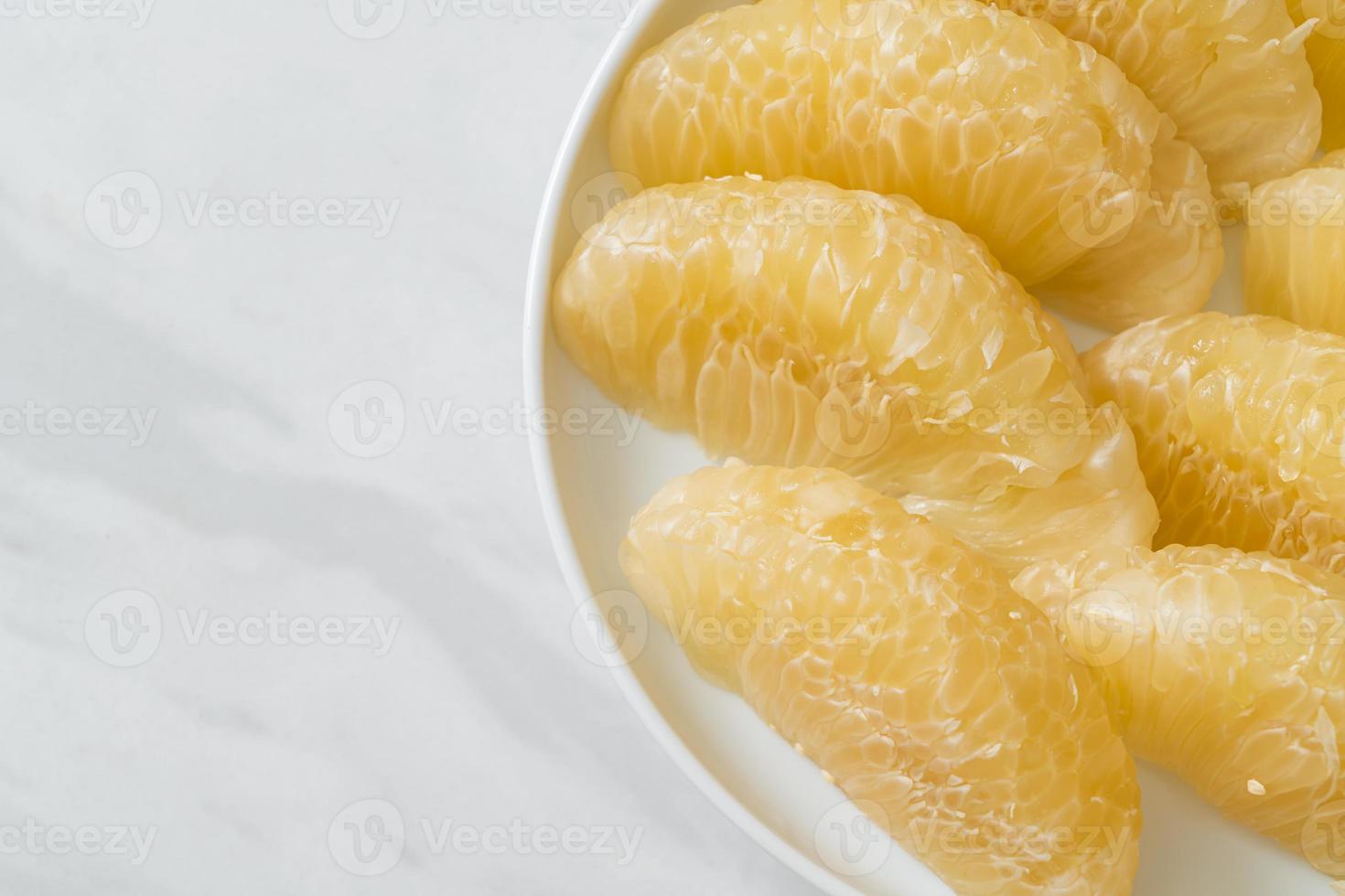 Fresh peeled pomelo, grapefruit or shaddock photo