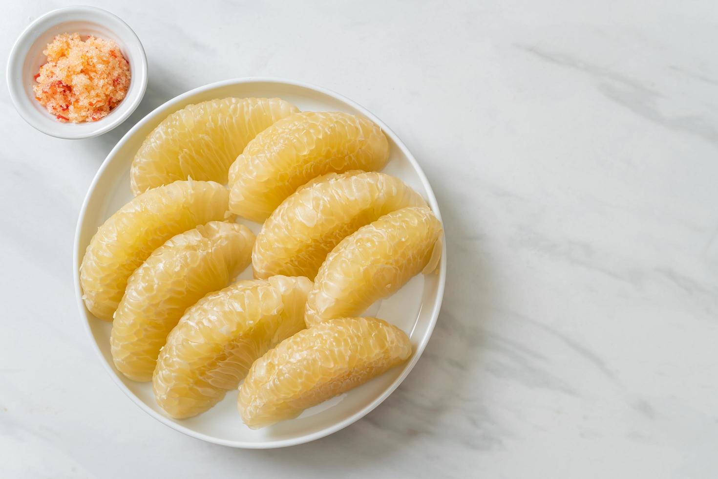 Fresh peeled pomelo, grapefruit or shaddock photo