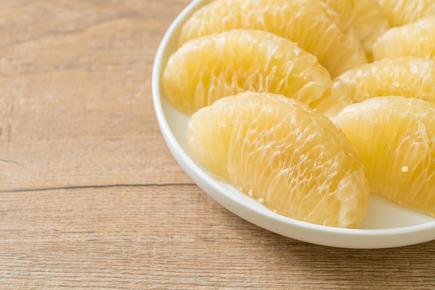 Fresh peeled pomelo, grapefruit or shaddock photo