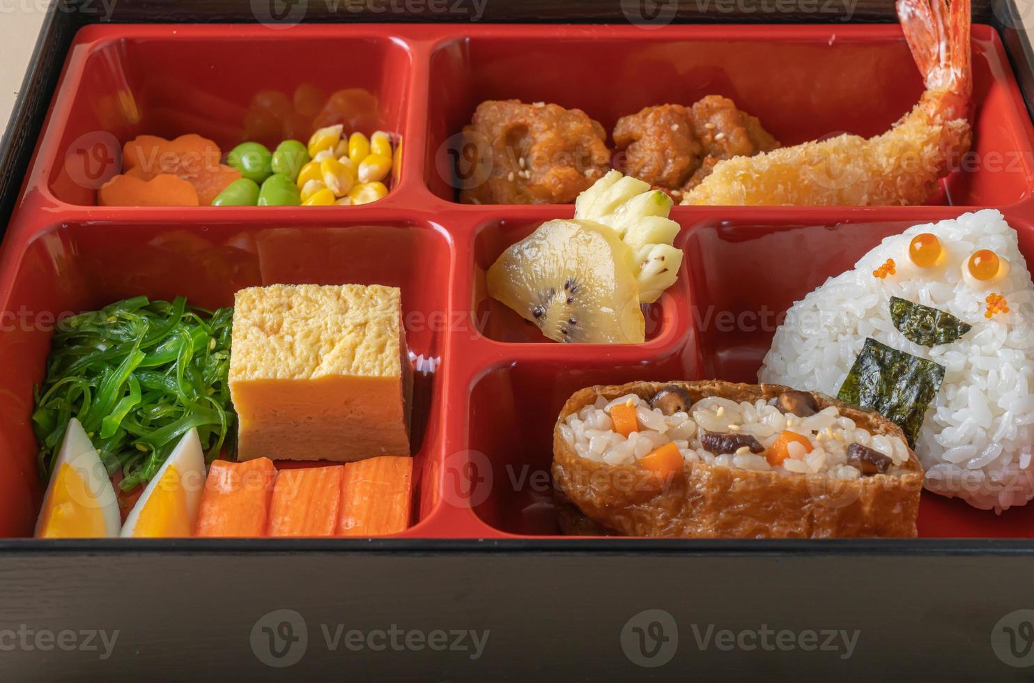Inari sushi rice wrapped in dried tofu with fried shrimp and fried chicken in bento set - Japanese food style photo