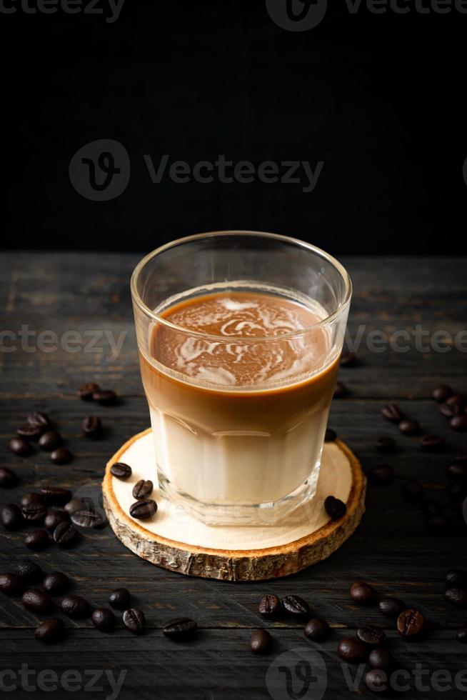 Glass of latte coffee, coffee with milk on wood background photo