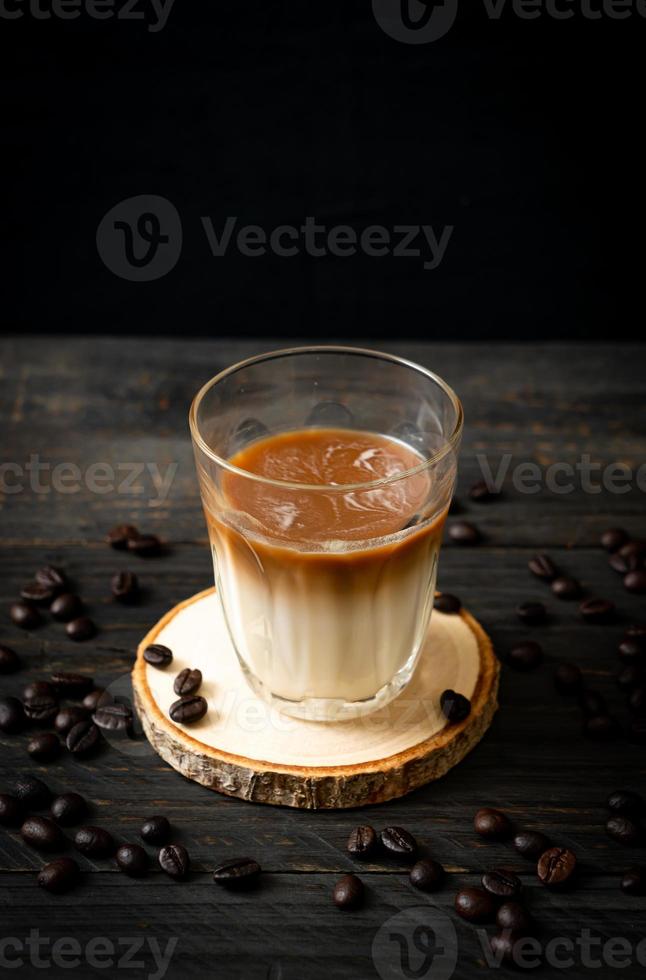 Glass of latte coffee, coffee with milk on wood background photo