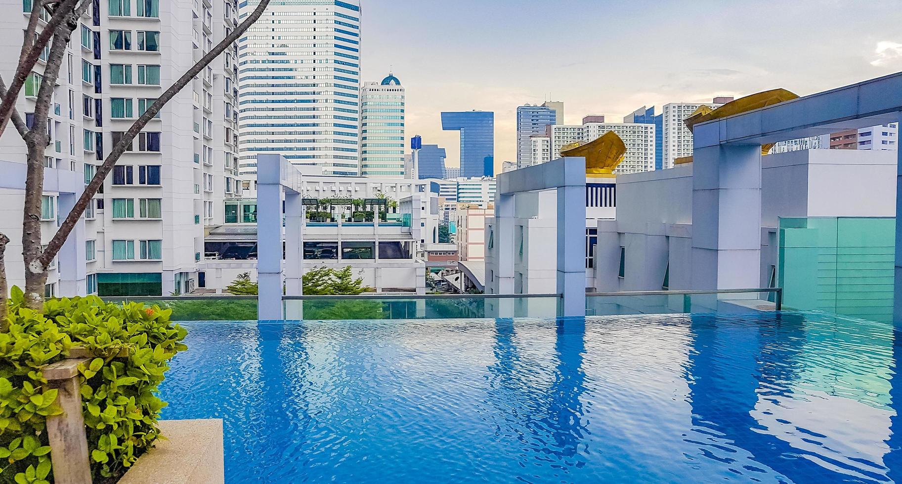 Skyscraper view from swimming infinity pool in Bangkok, Thailand photo