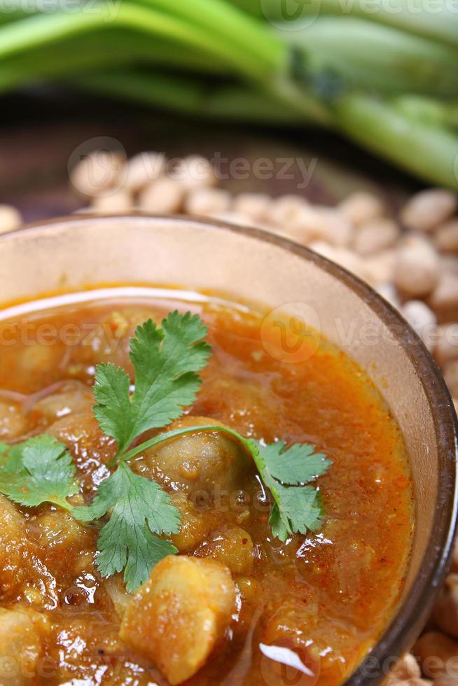 Indian spicy chana masala with raw chickpeas photo