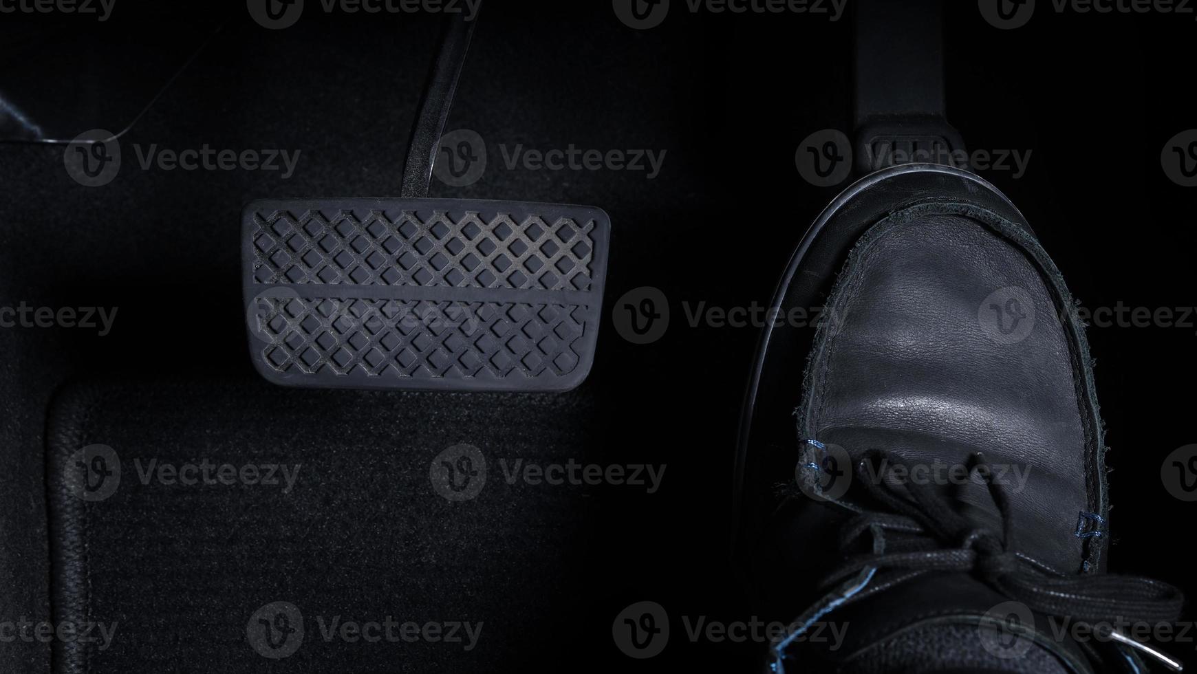 Close up images of man driving car by pushing accelerator and brake pedal photo