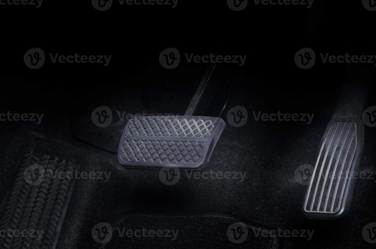 Close up images of man driving car by pushing accelerator and brake pedal photo