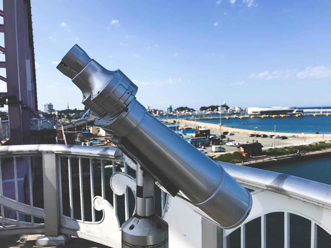 Observation binoculars on the bridge and Sokcho city on the background, South Korea photo