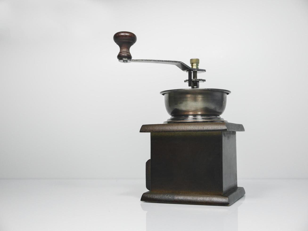 The wooden coffee grinder on grey background photo