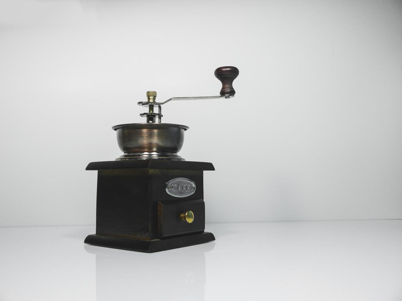 The wooden coffee grinder on grey background photo