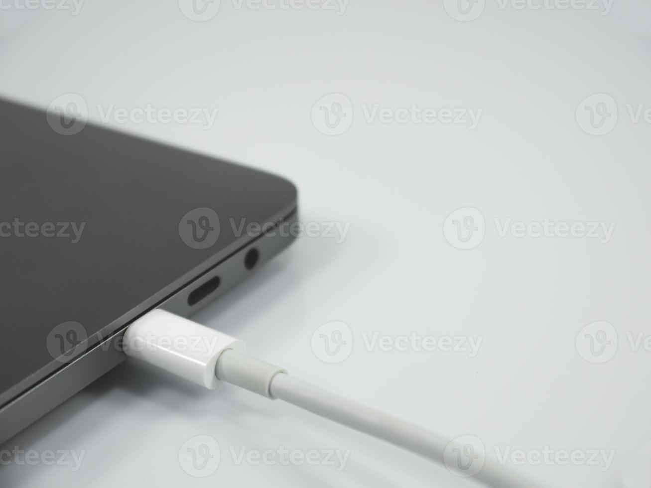 Type C cable and laptop on the white background photo