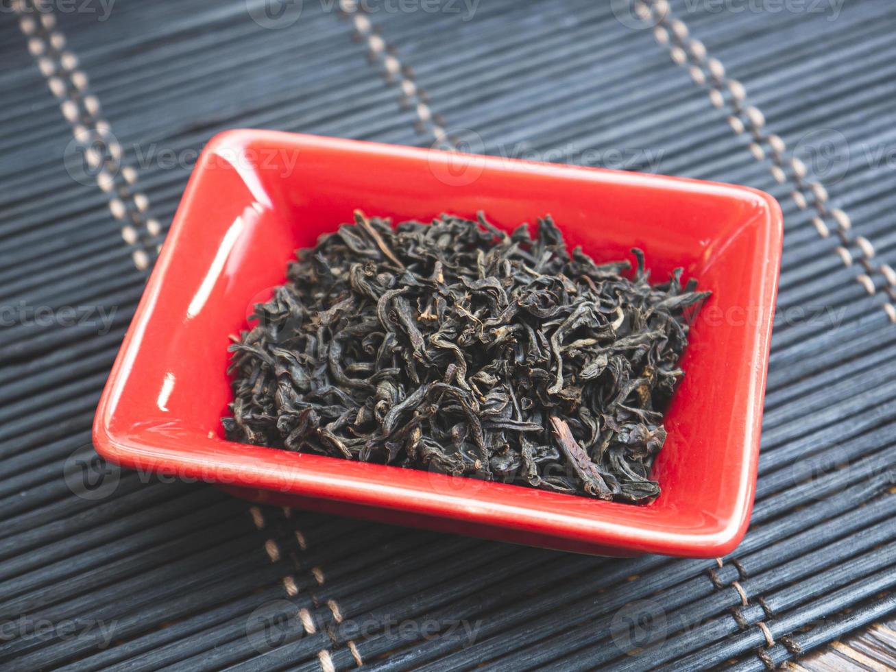 Chinese tea in small red plate. Close-up photo