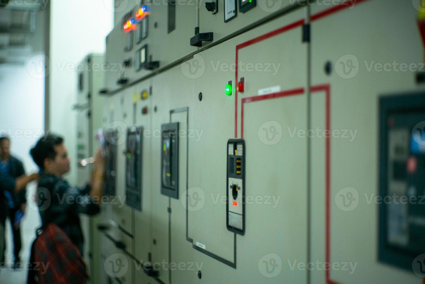 Blurred portrait of technician doing the preventive maintenance in the control room photo