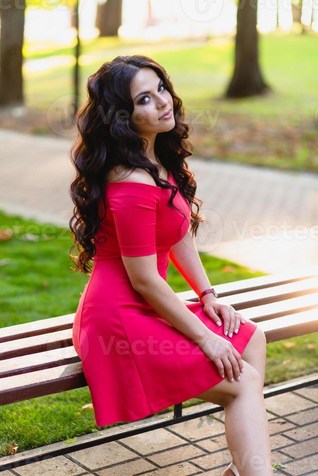 Portrait of a beautiful young girl with long dark wavy hair photo