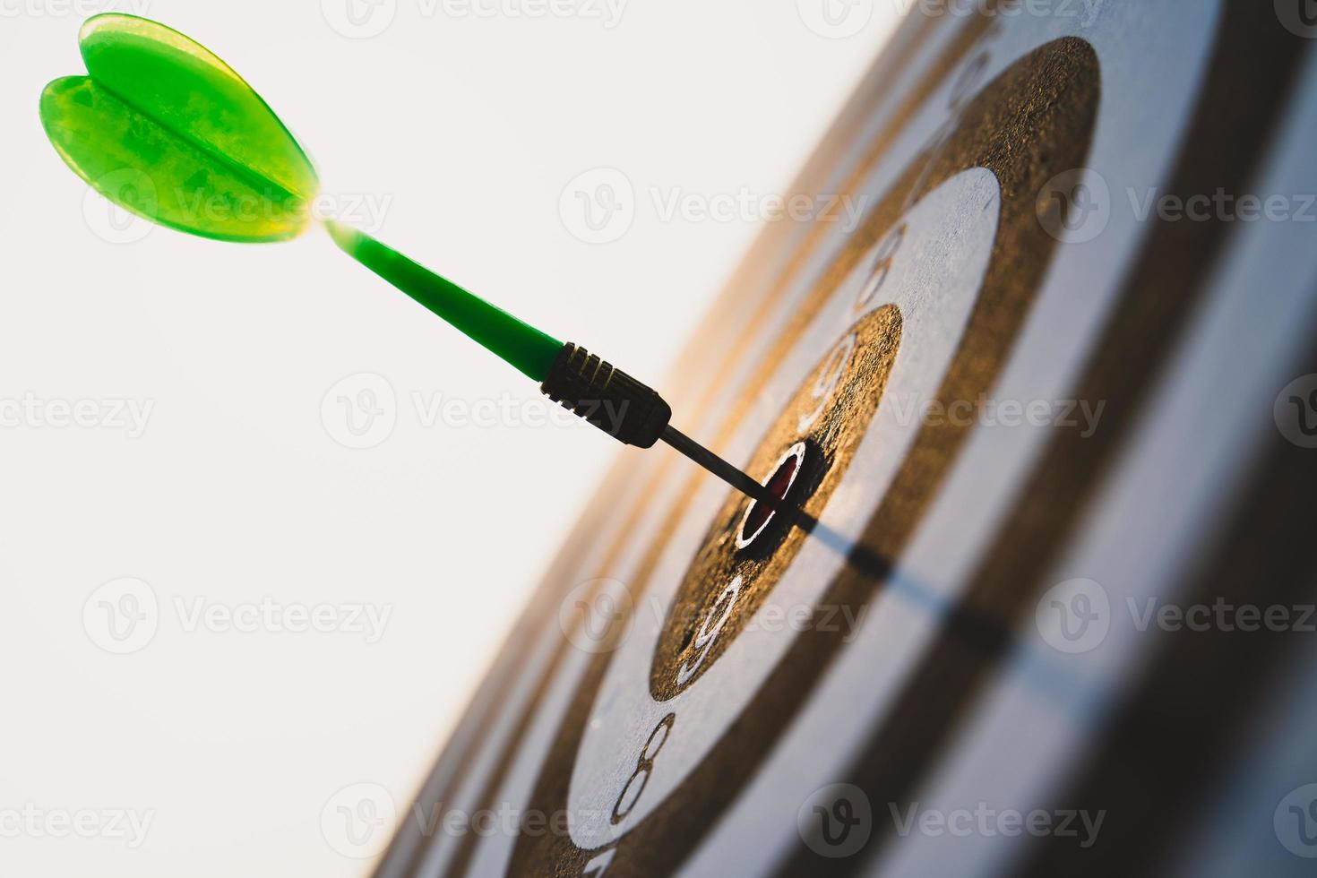 Green darts arrows in the target center on the sky background. Business target or goal success and winner concept. photo