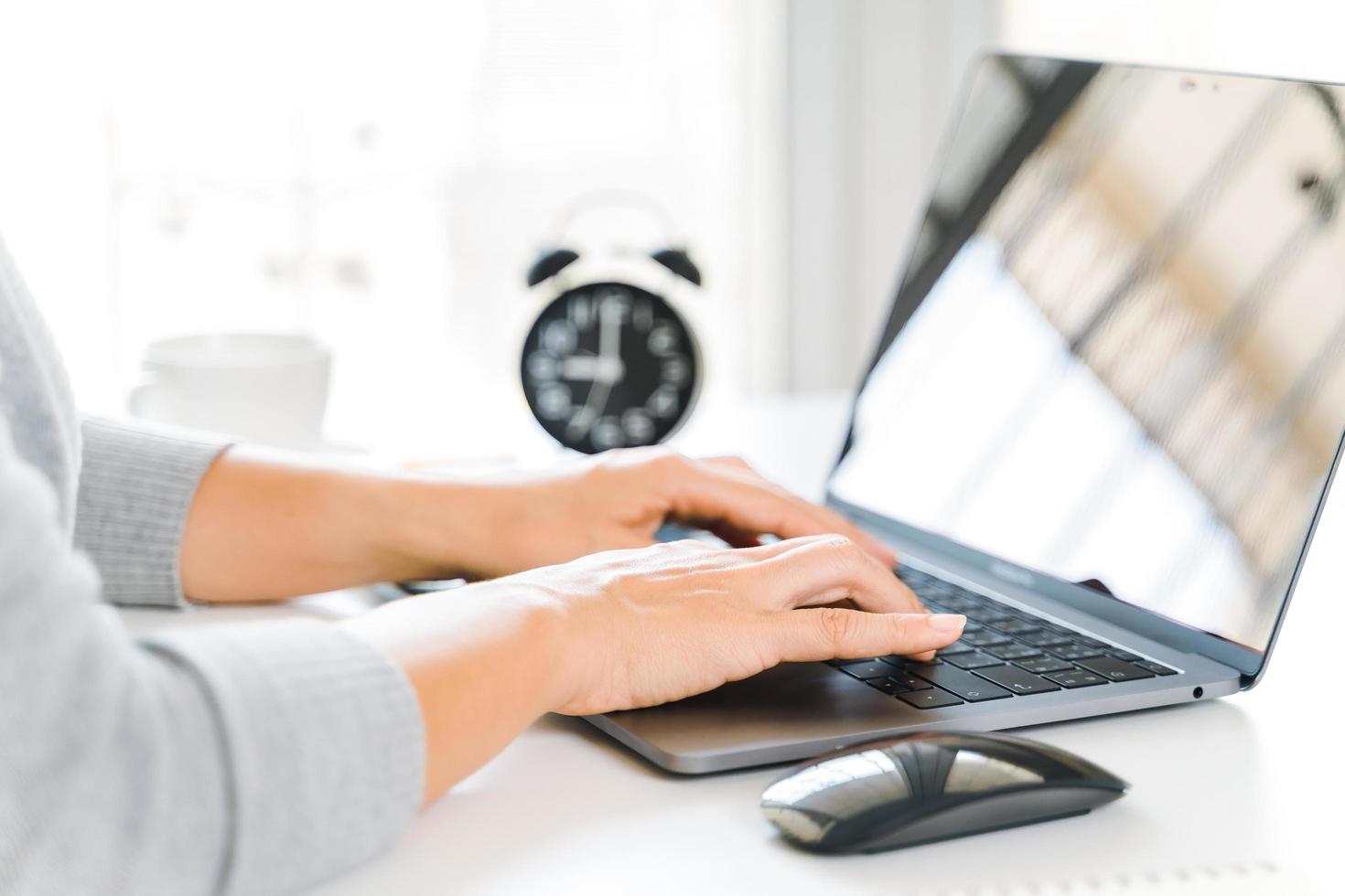 Businesswoman typing on laptop at home office or workplace. photo