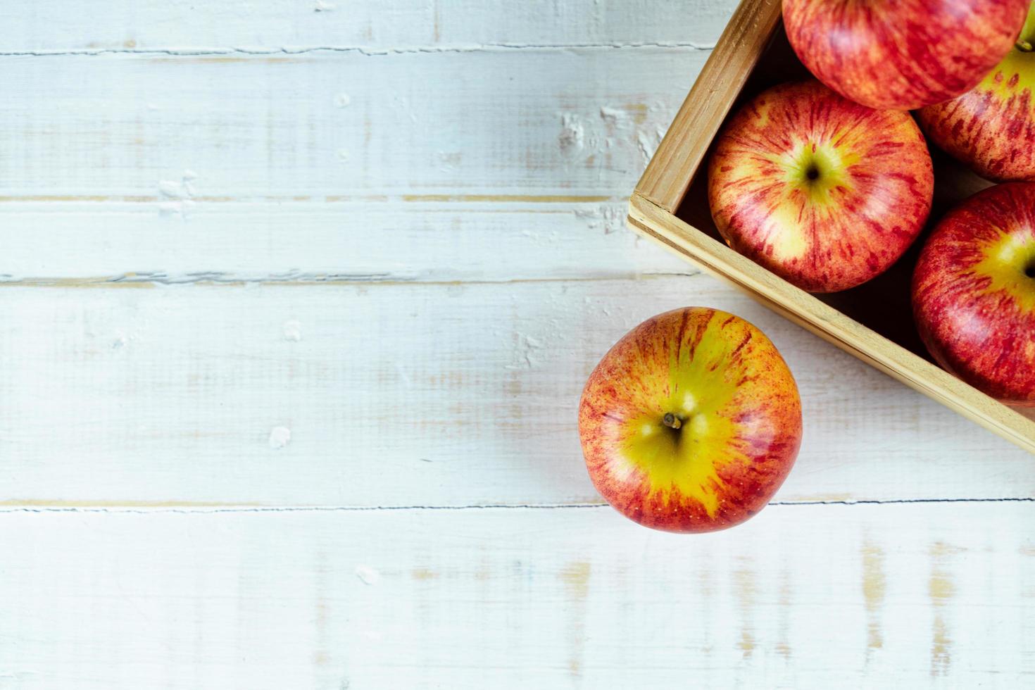 Fresh red apples on wooden background. photo