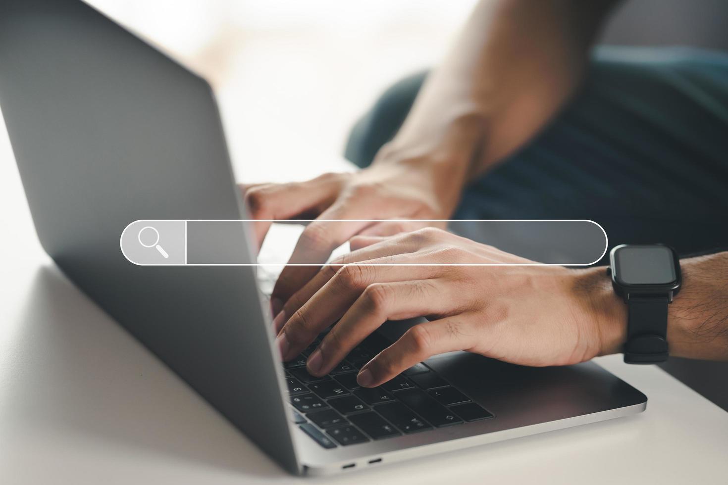 Man using a laptop computer to Searching for information with the Search bar, Web browser, Data Search, Search Engine, Technology Concept photo