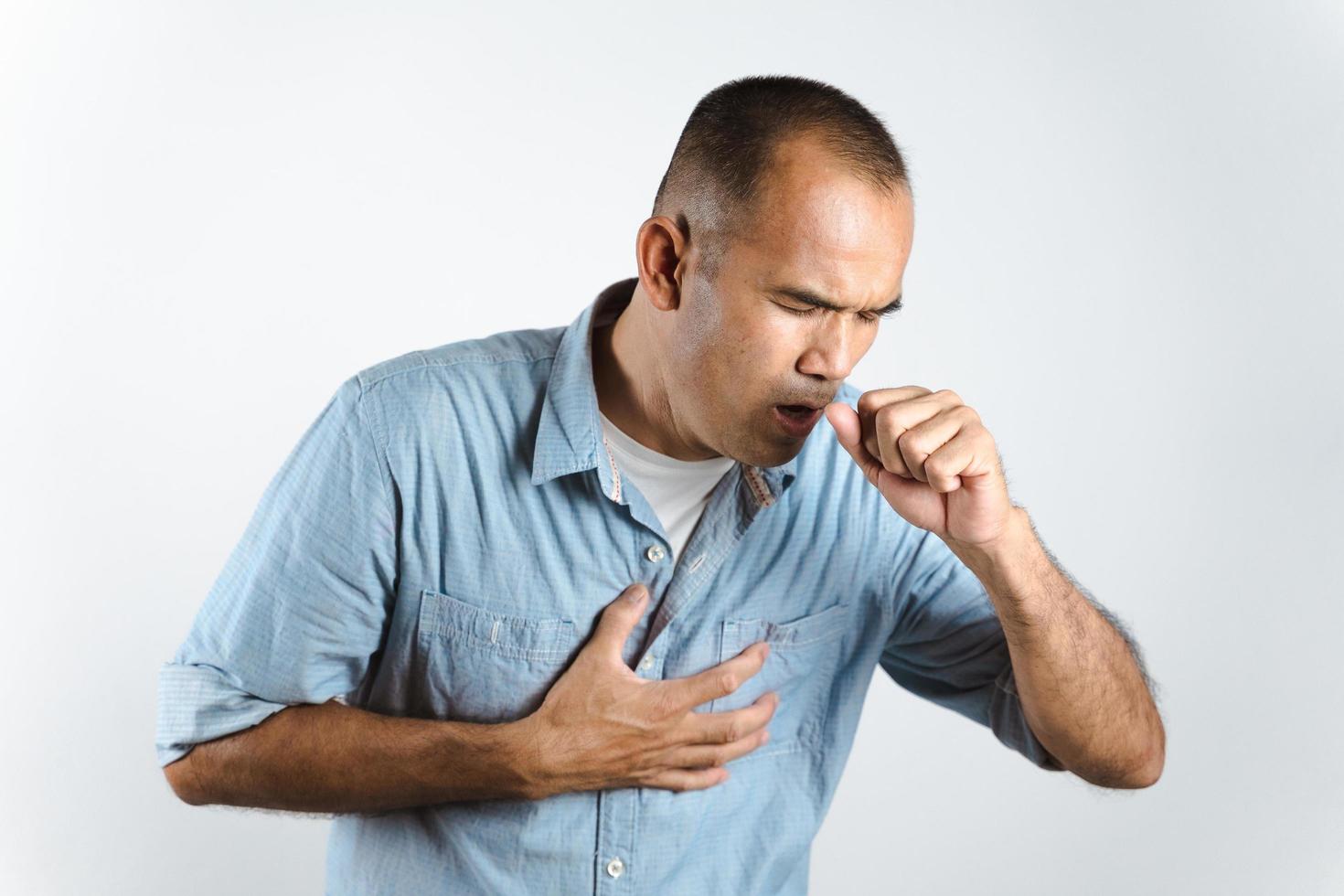 Man sneezing or coughing over his hand to prevent spread the virus COVID-19 or Corona Virus on white background. photo