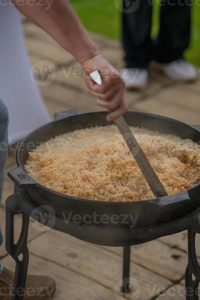 The process of cooking pilaf. National dish of oriental cuisine. photo