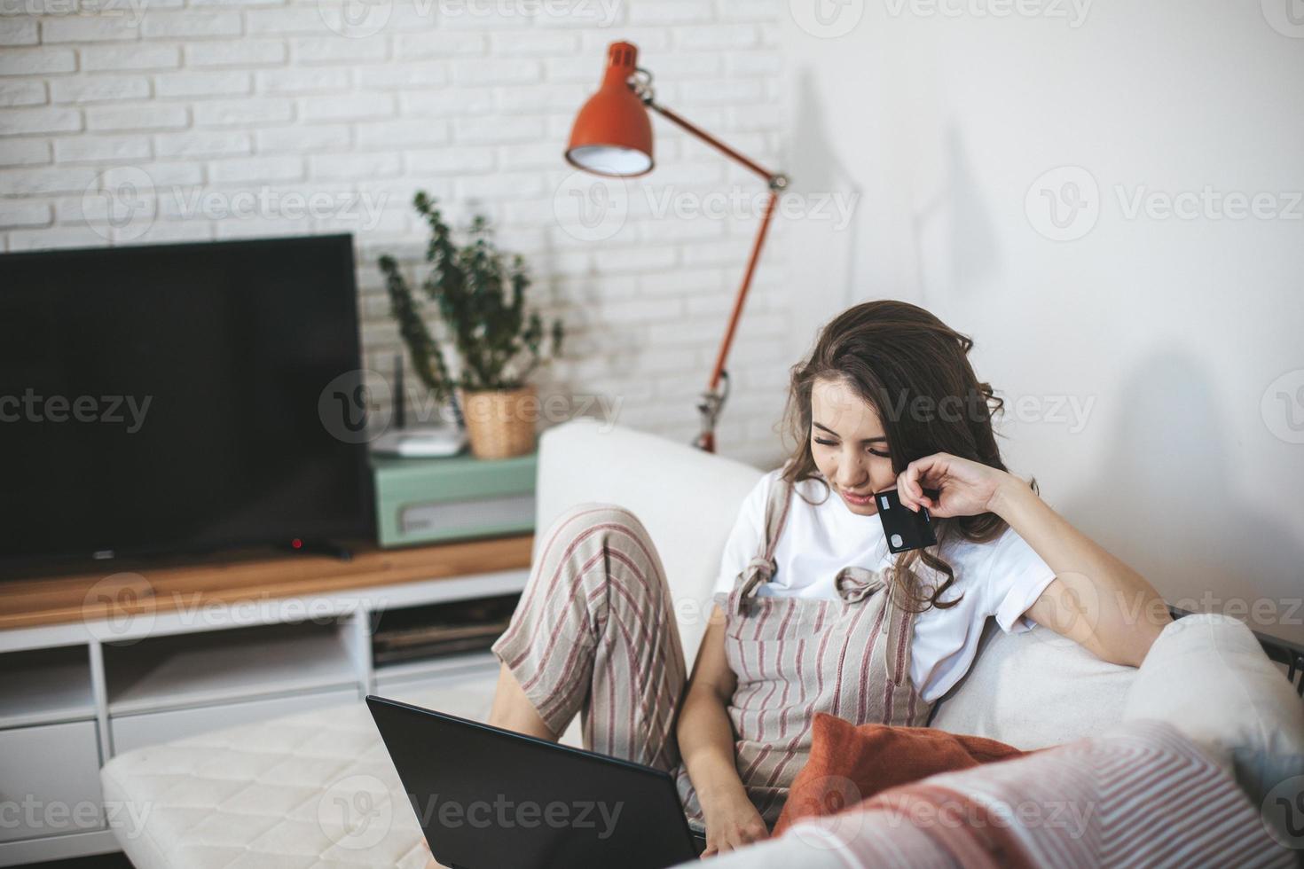 Young millennial woman shopping online at home. photo
