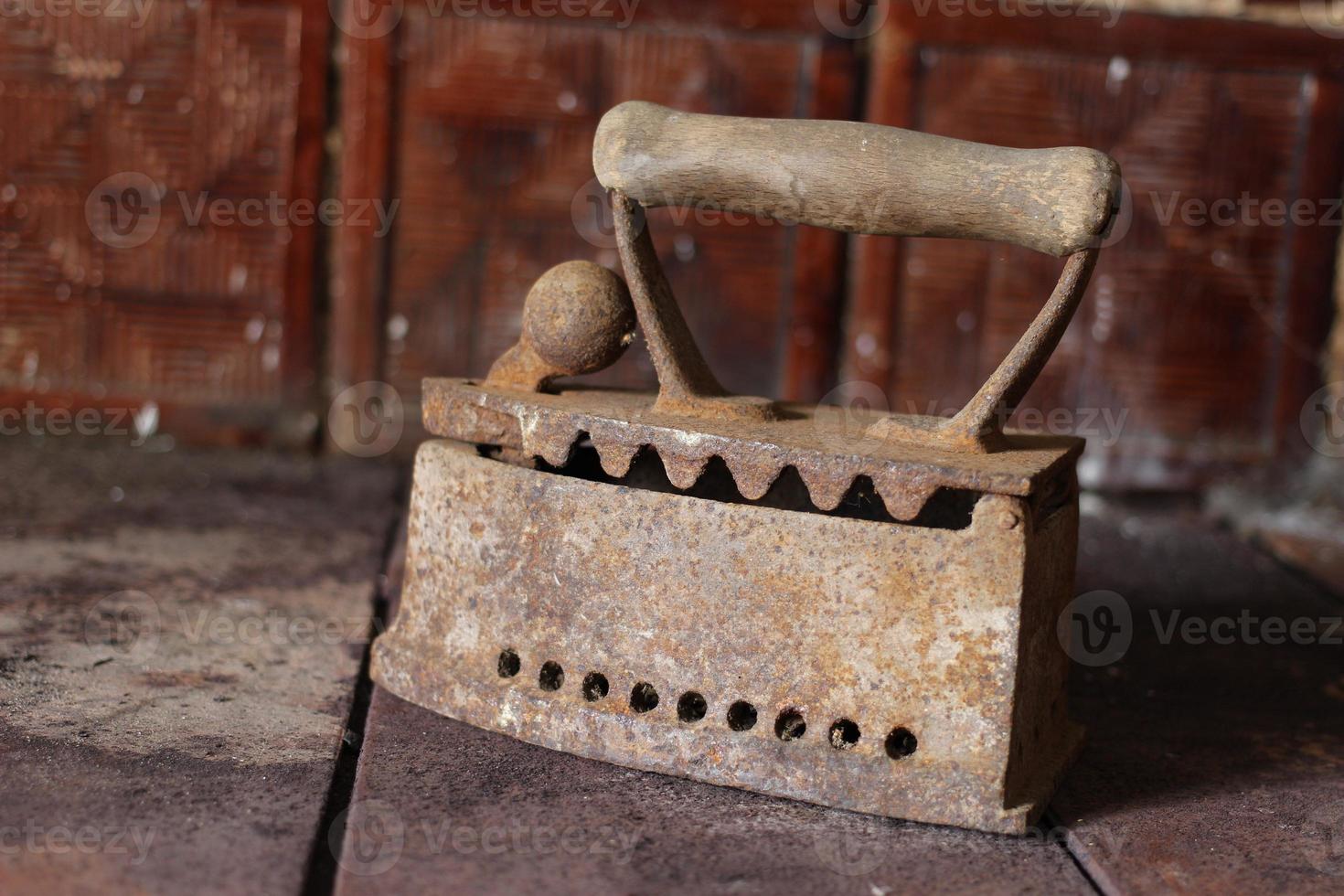 Old rusty smoothing iron in the house. photo