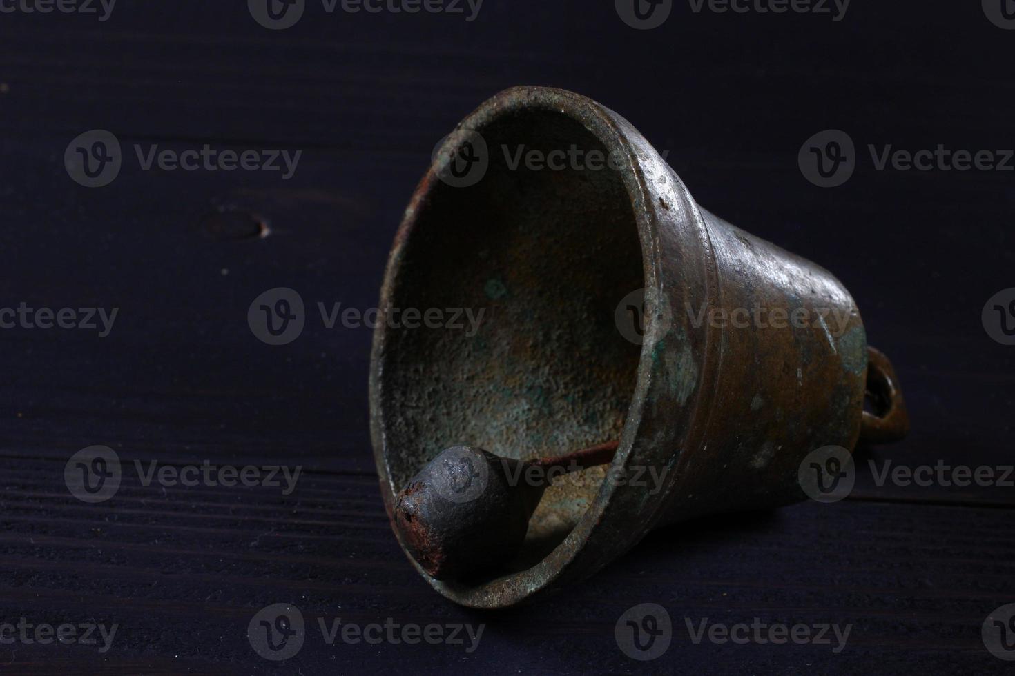 Old bell on a dark background photo