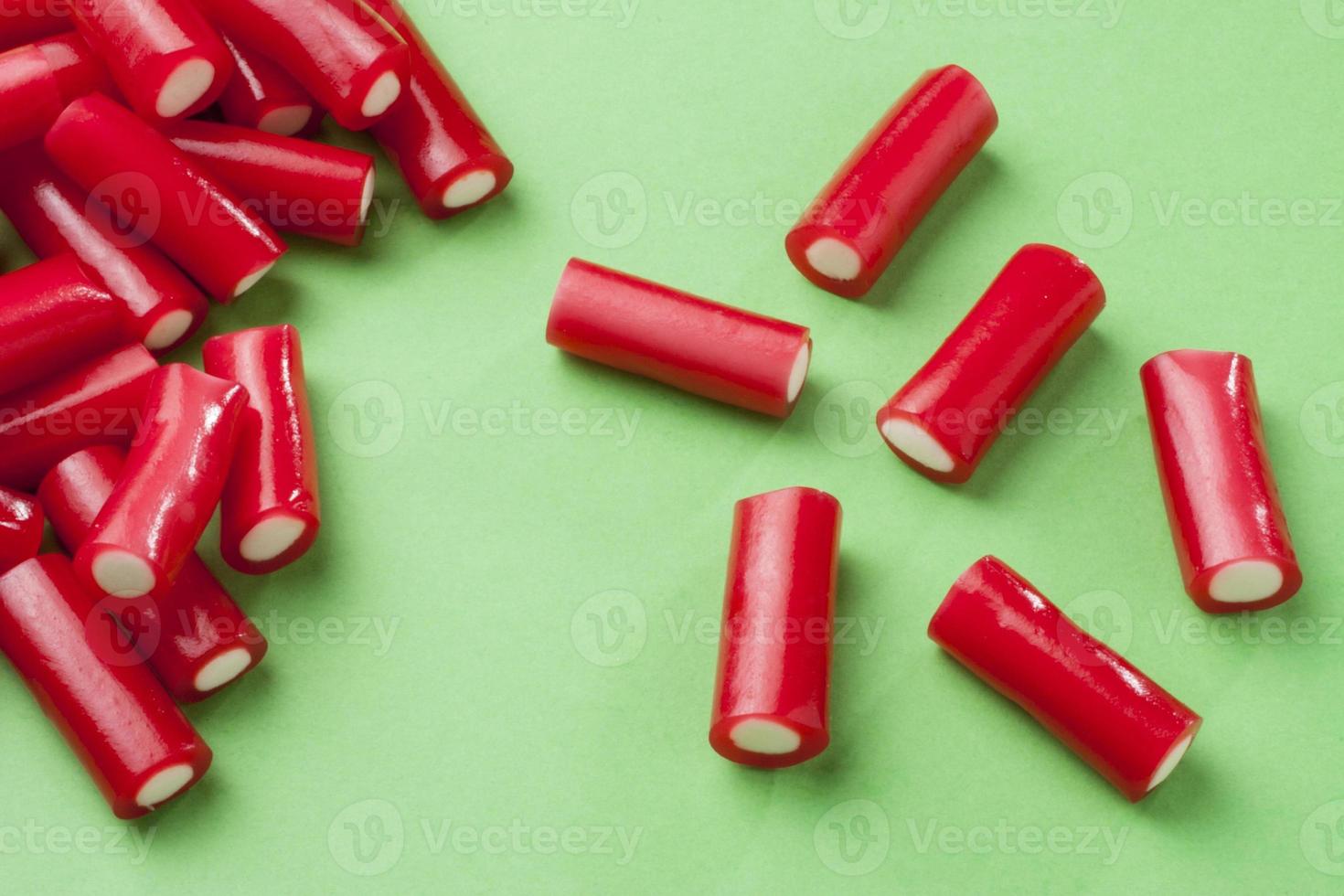 Colorful candy on green background photo