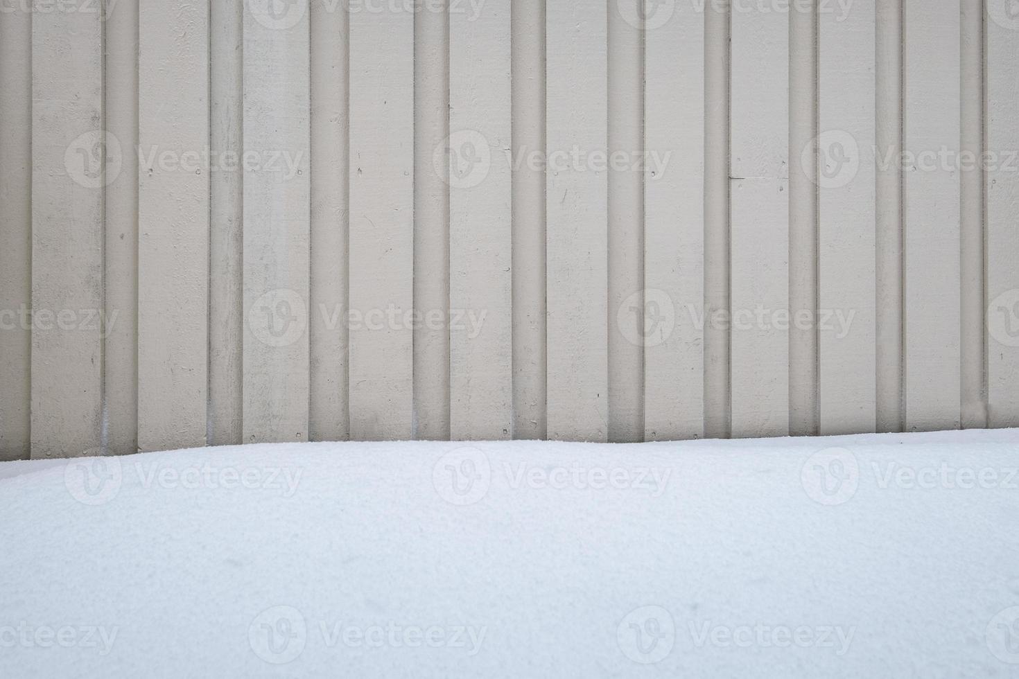 Wooden striped wall with snow covered photo