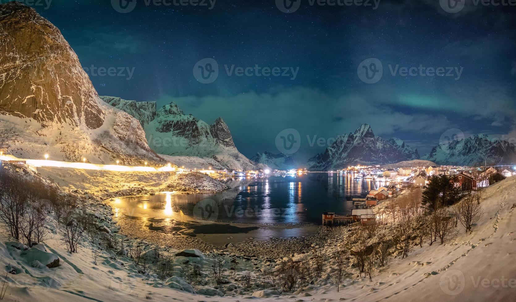 Panorama of Aurora borealis over scandinavian village in winter photo