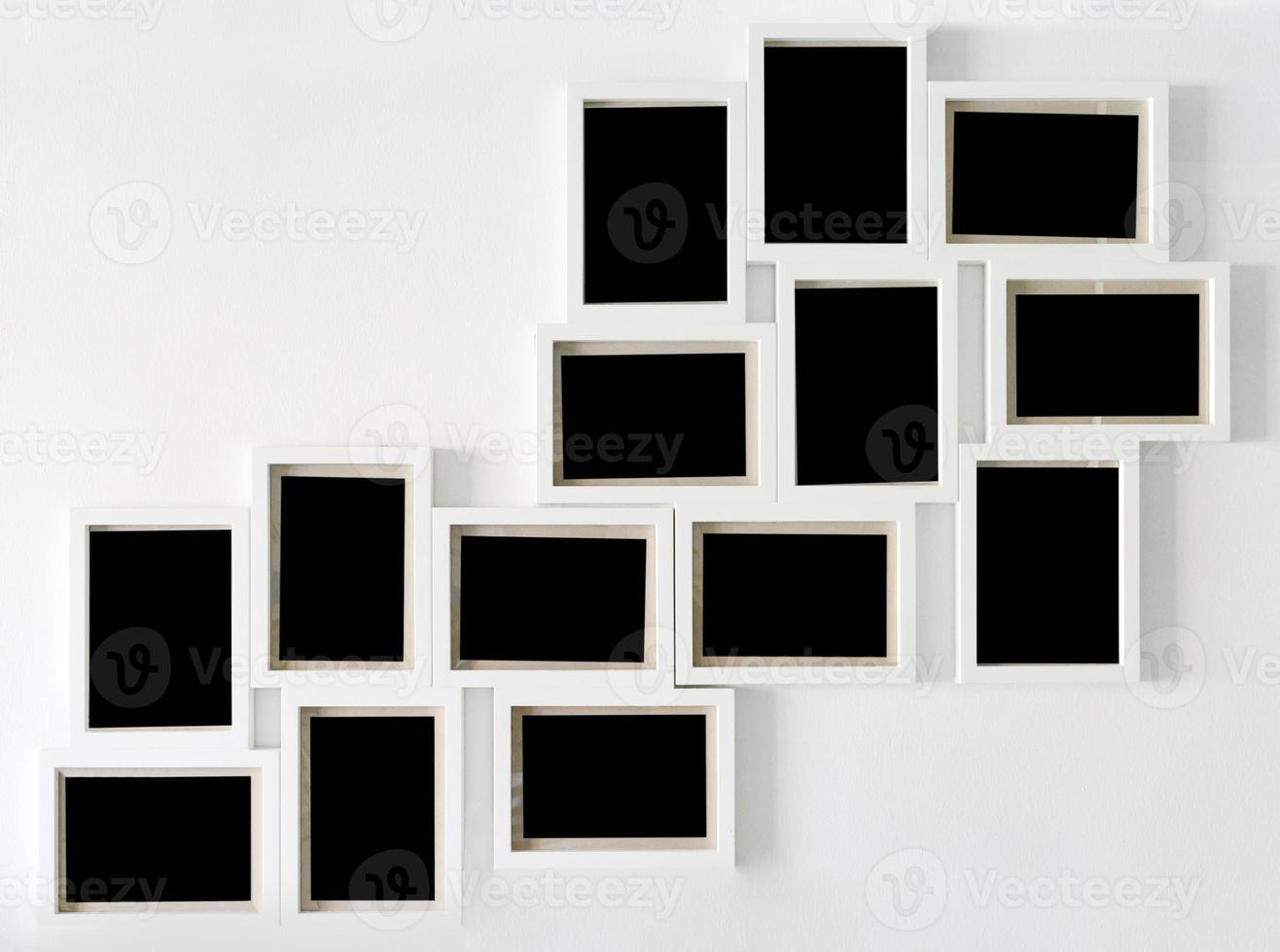 White picture frame and black decorative hanging on white wall photo