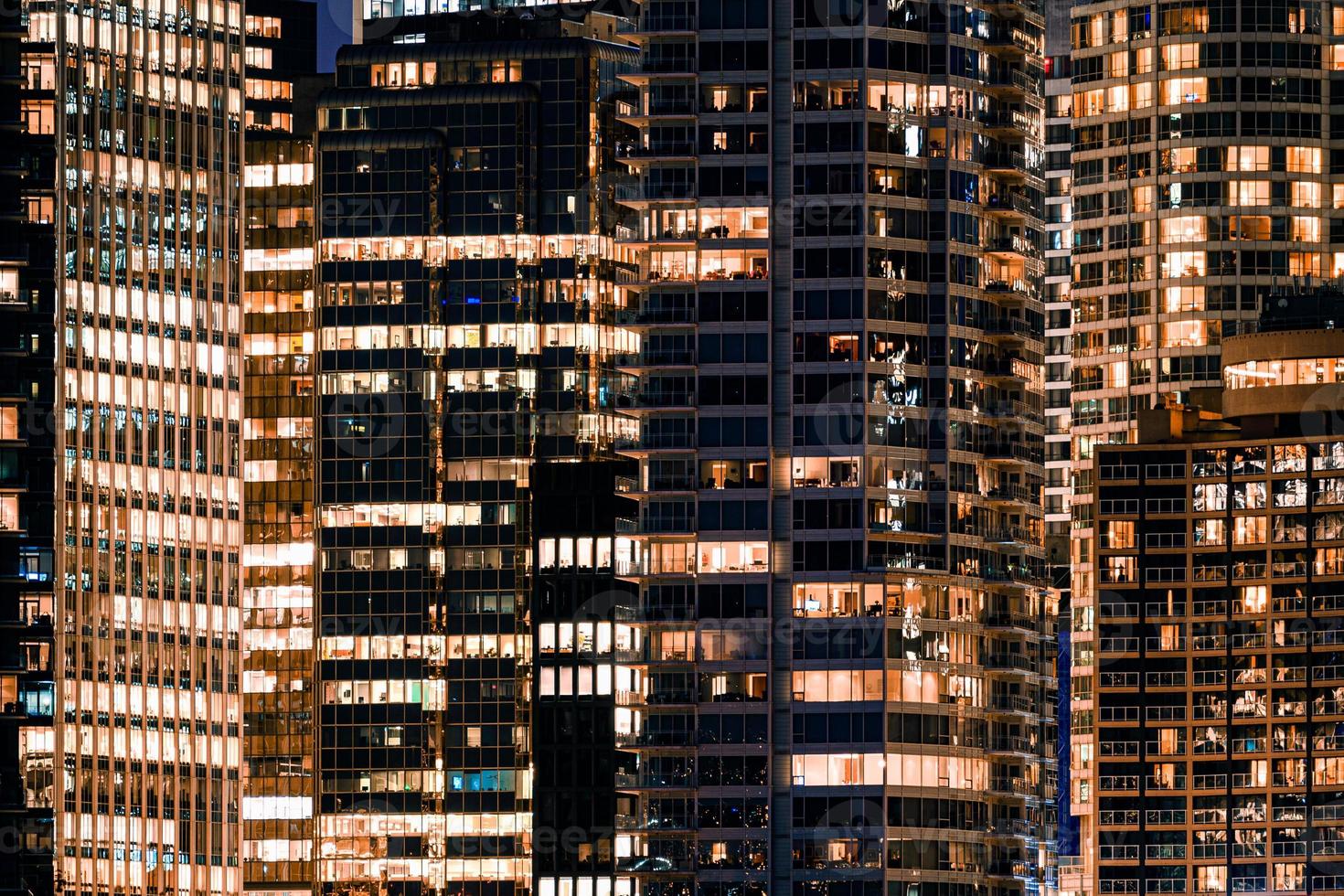 Facade windows of illuminated modern skyscraper with office building photo