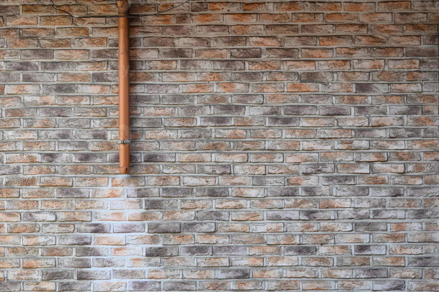 Brick wall with steel sewer and stain photo