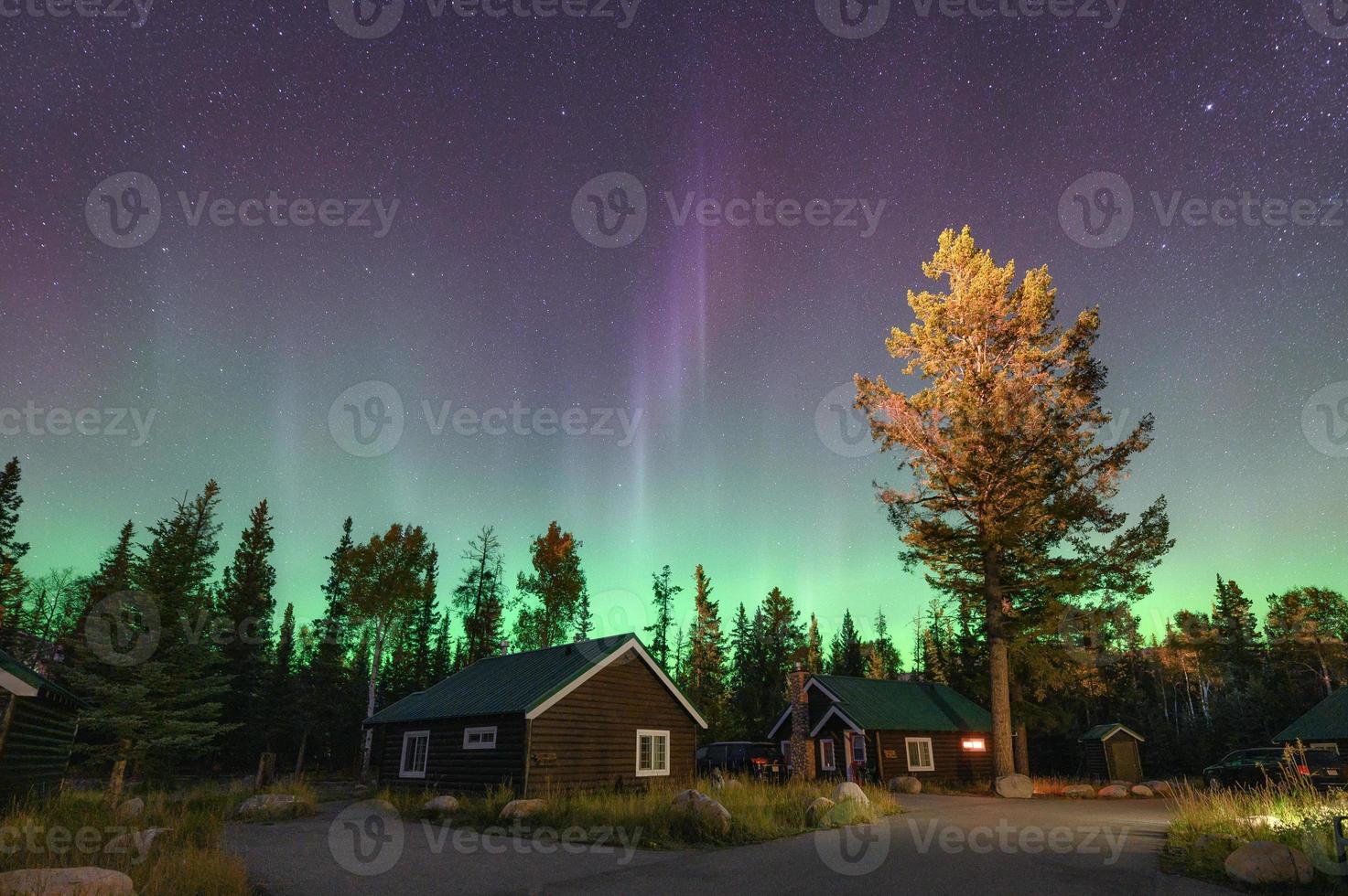 Aurora Borealis, Northern lights over wooden cottage in national park at Jasper photo