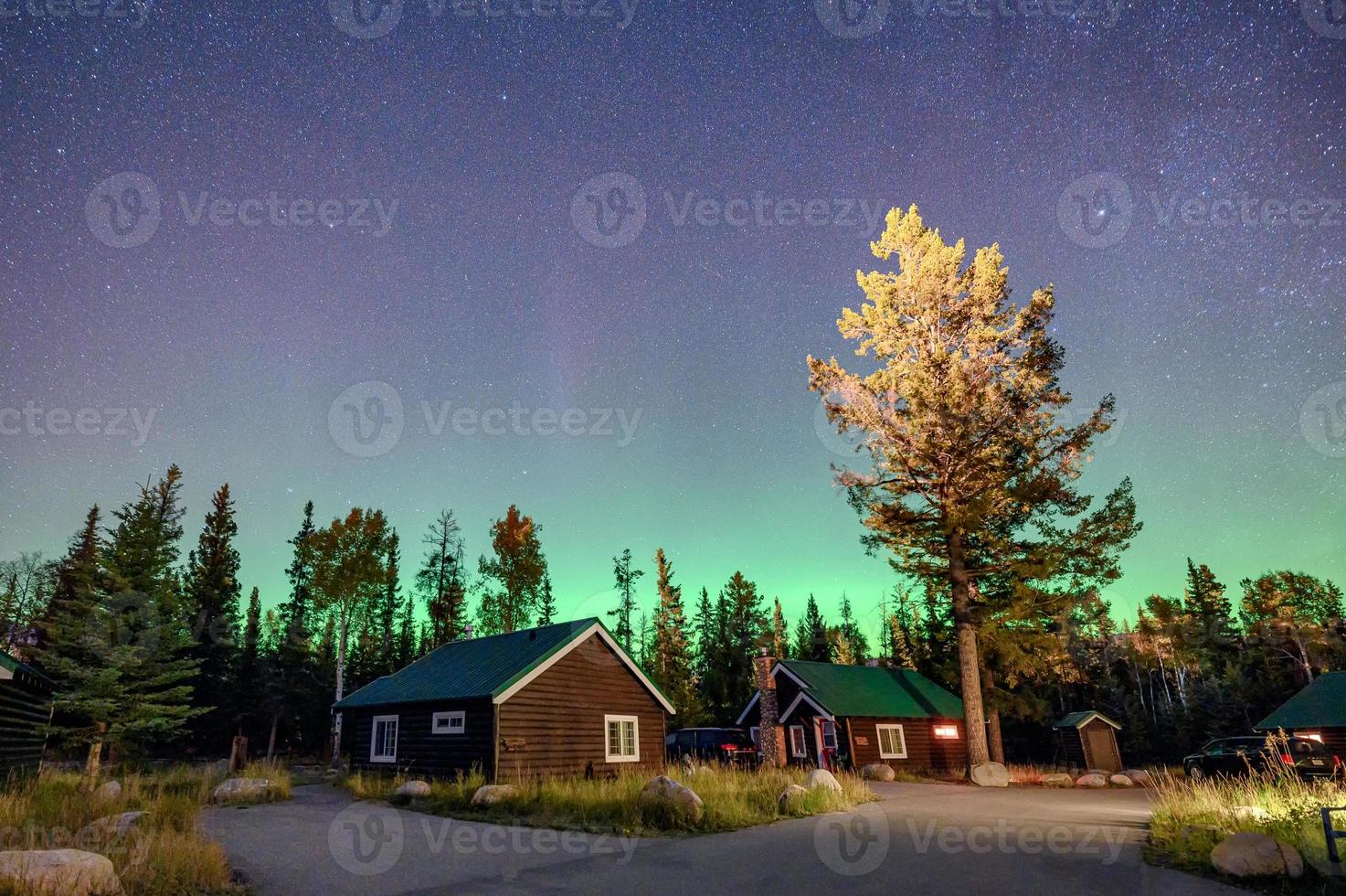 Aurora Borealis, Northern lights over wooden cottage in national park at Jasper photo