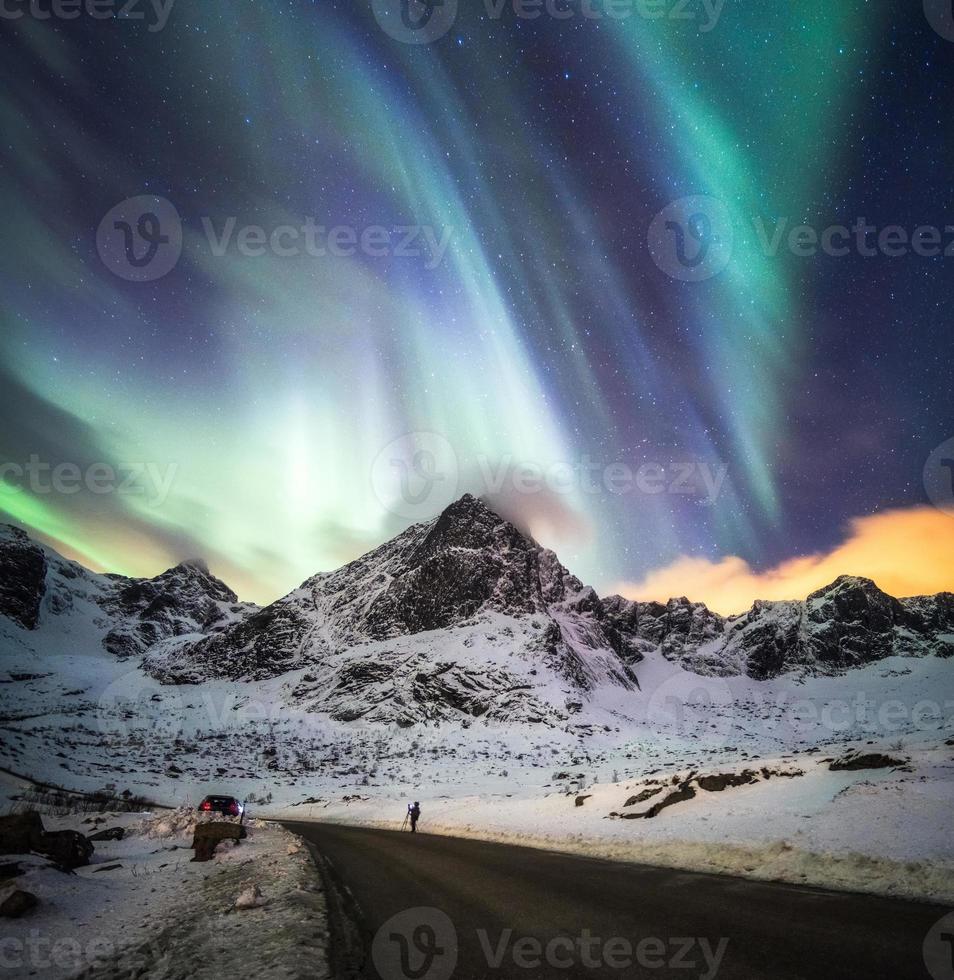 Aurora borealis, Northern lights explosion over snow mountain photo