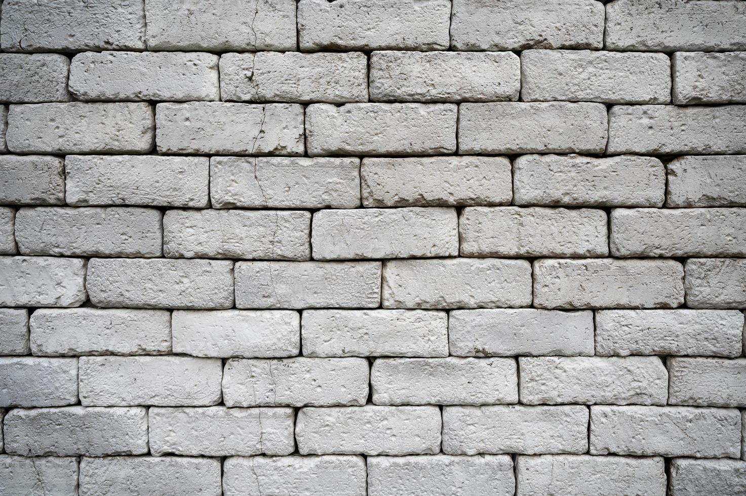 Weathered grey brick wall for texture and background photo