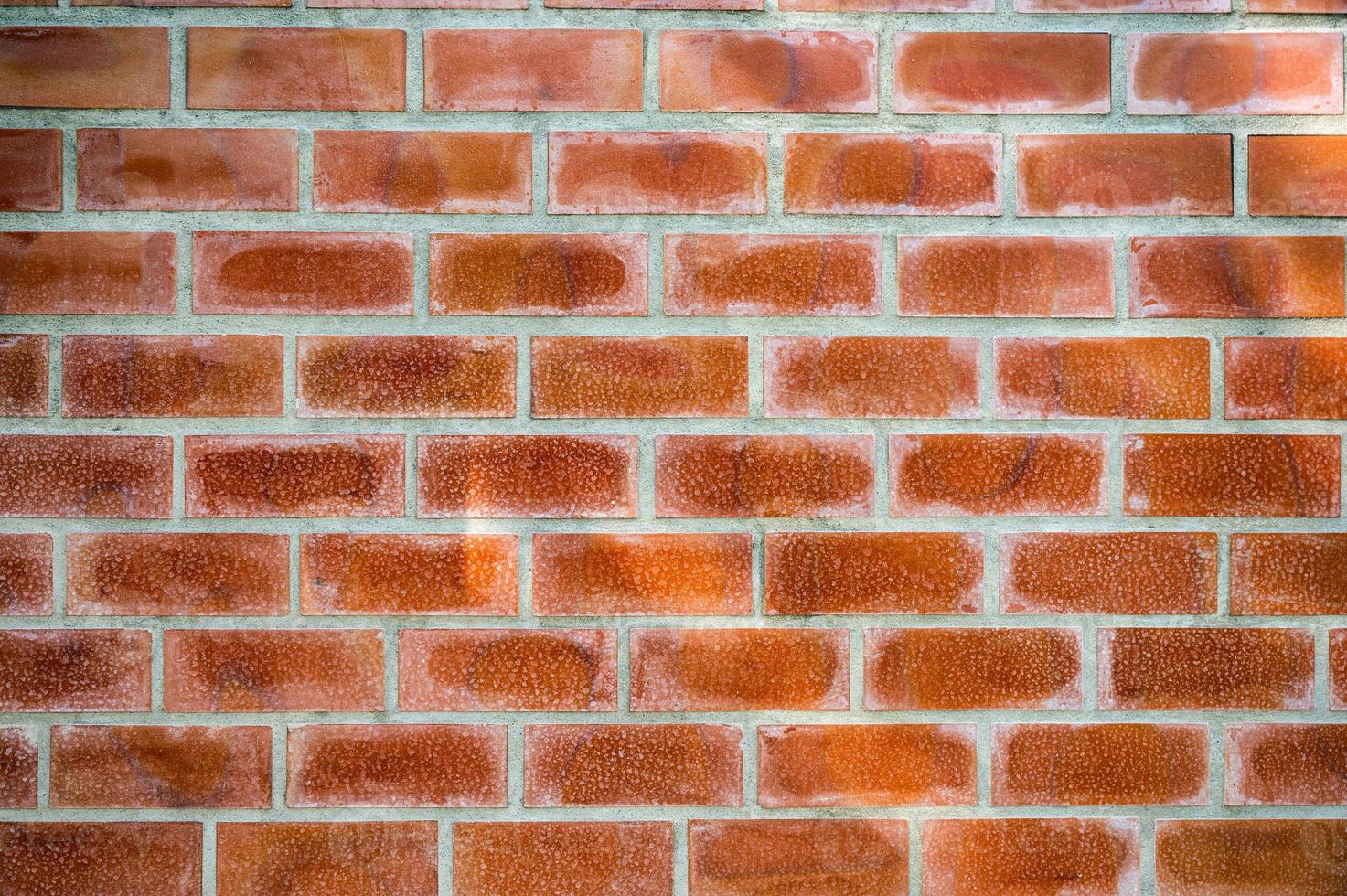 Orange bricks block on cement wall photo