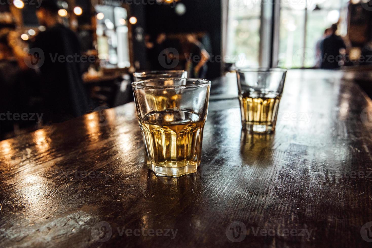 glasses of whiskey on the table photo