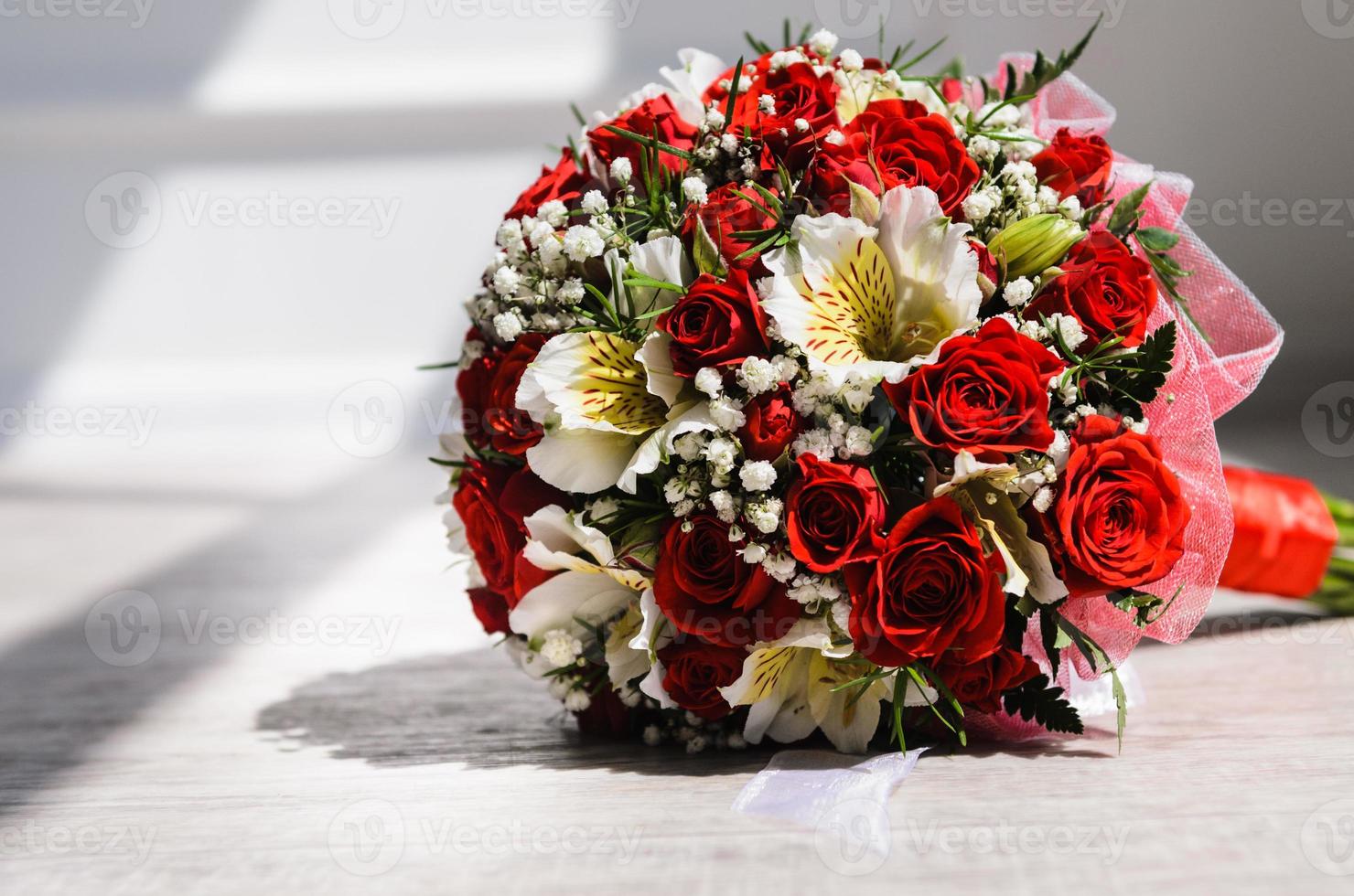 brides bouquet on a vintage wooden floor photo