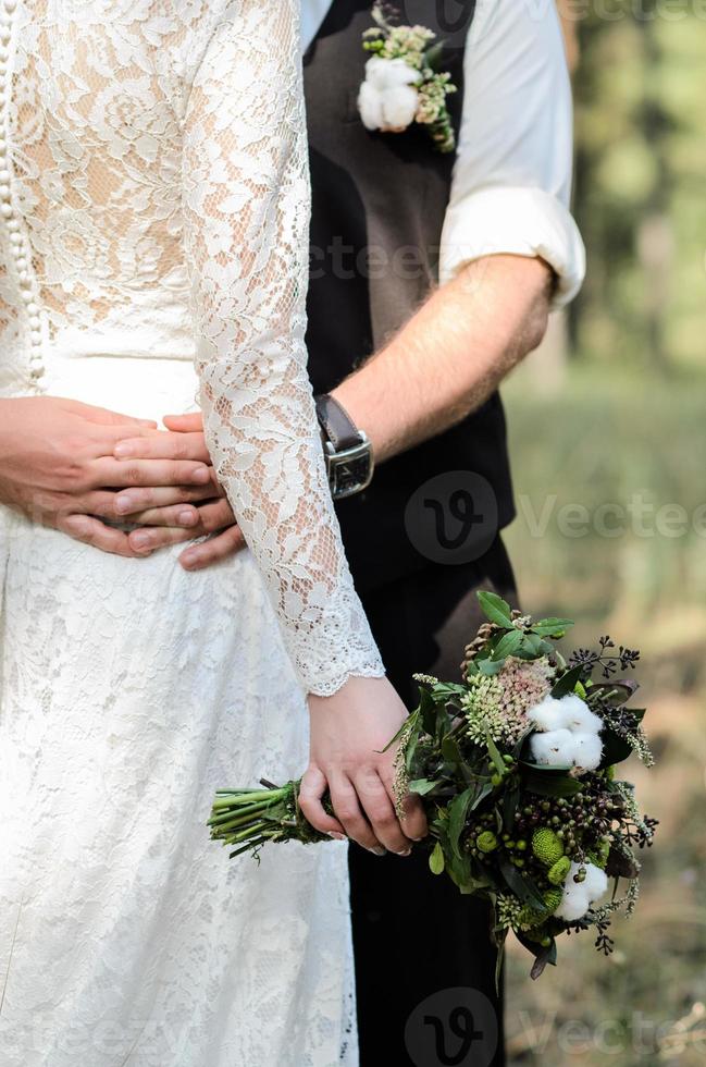 the groom and bride are hugging photo