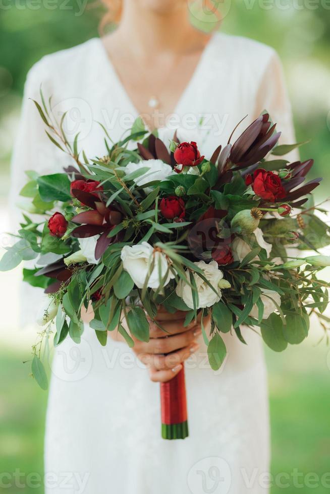 wedding bouquet of red flowers and greenery photo