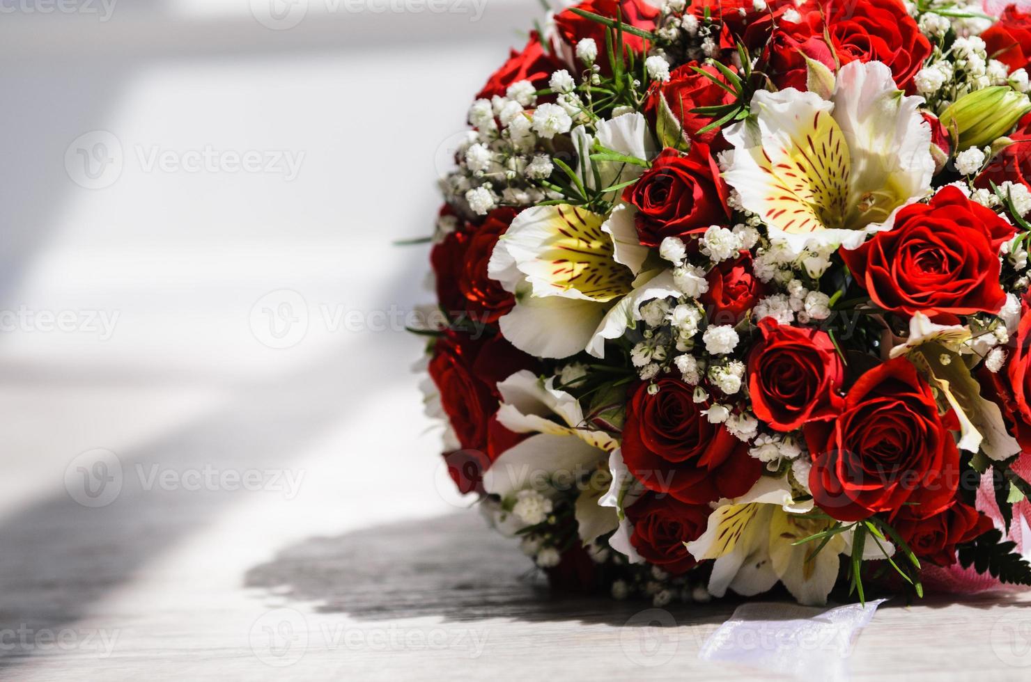 brides bouquet on a vintage wooden floor photo