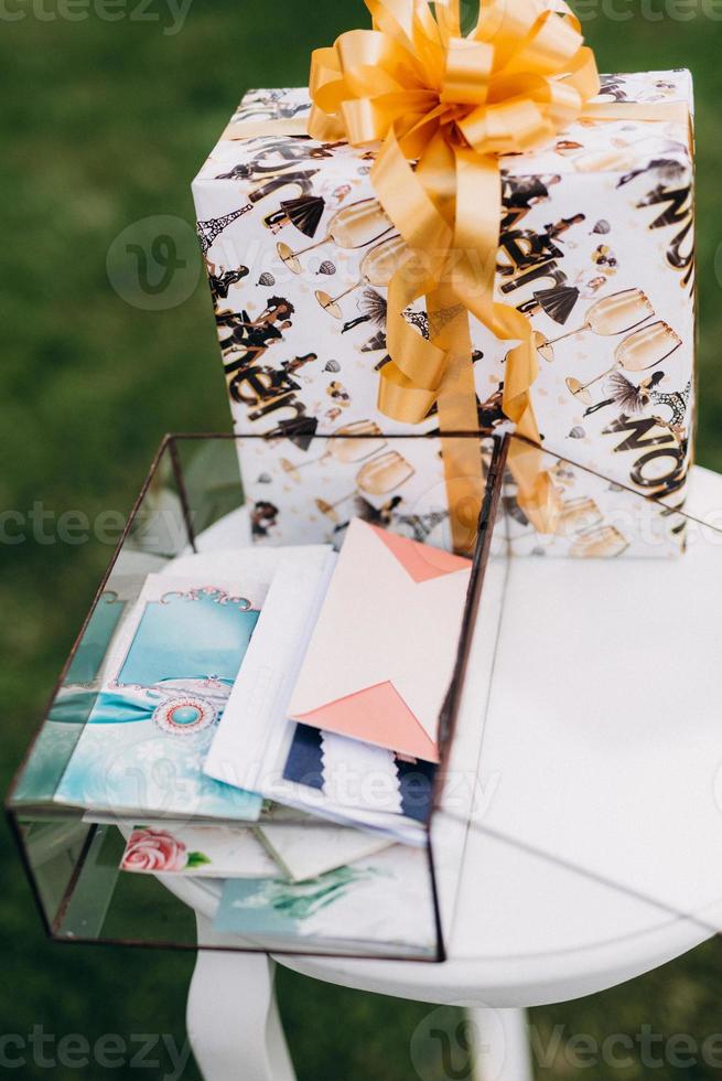 glass box with wedding gifts in envelopes photo