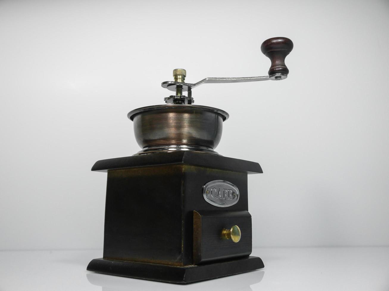 The wooden coffee grinder on grey background photo